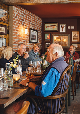 Group of people eating at pub.